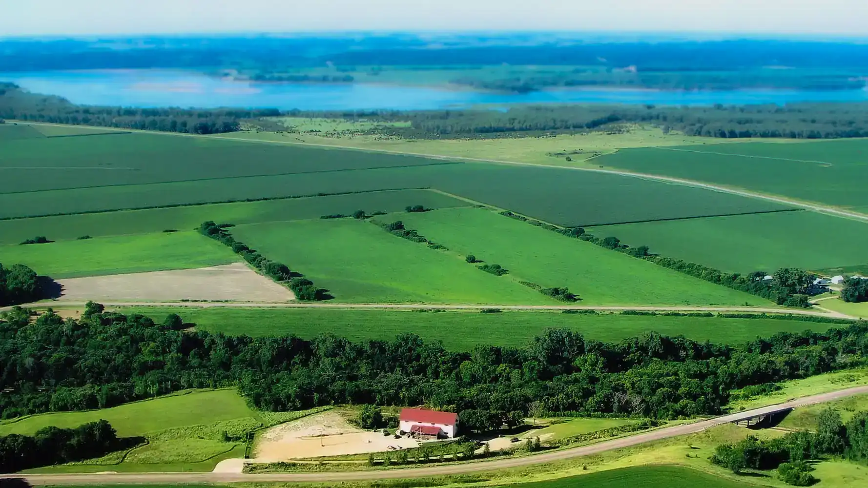 Aerial view of Valiant Vineyards surrounded by green fields with Missouri River in background
