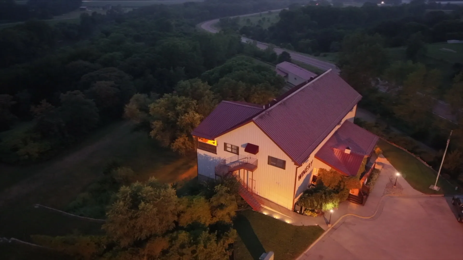 Valiant Vineyards winery building lit at dusk, seen from above