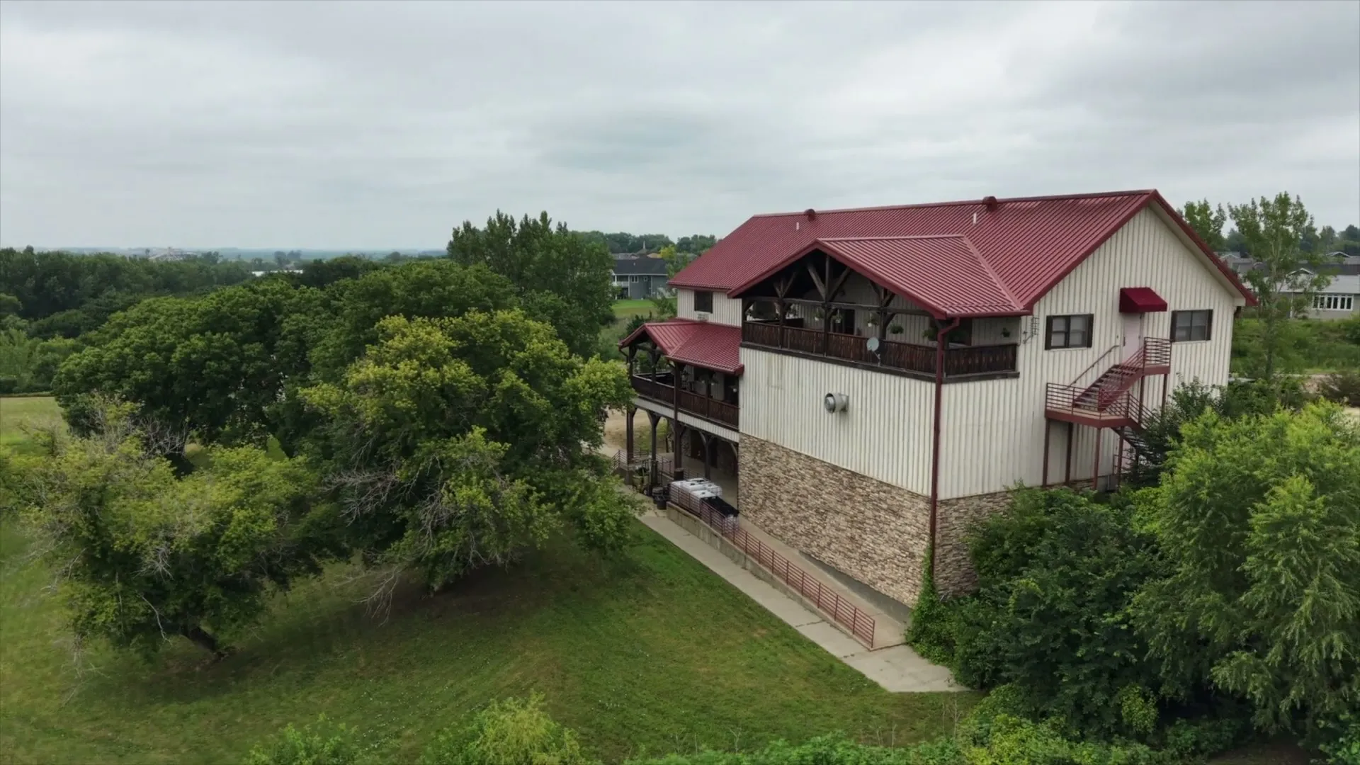 Aerial view of the Valiant Vineyards winery and surrounding trees on a summer day.