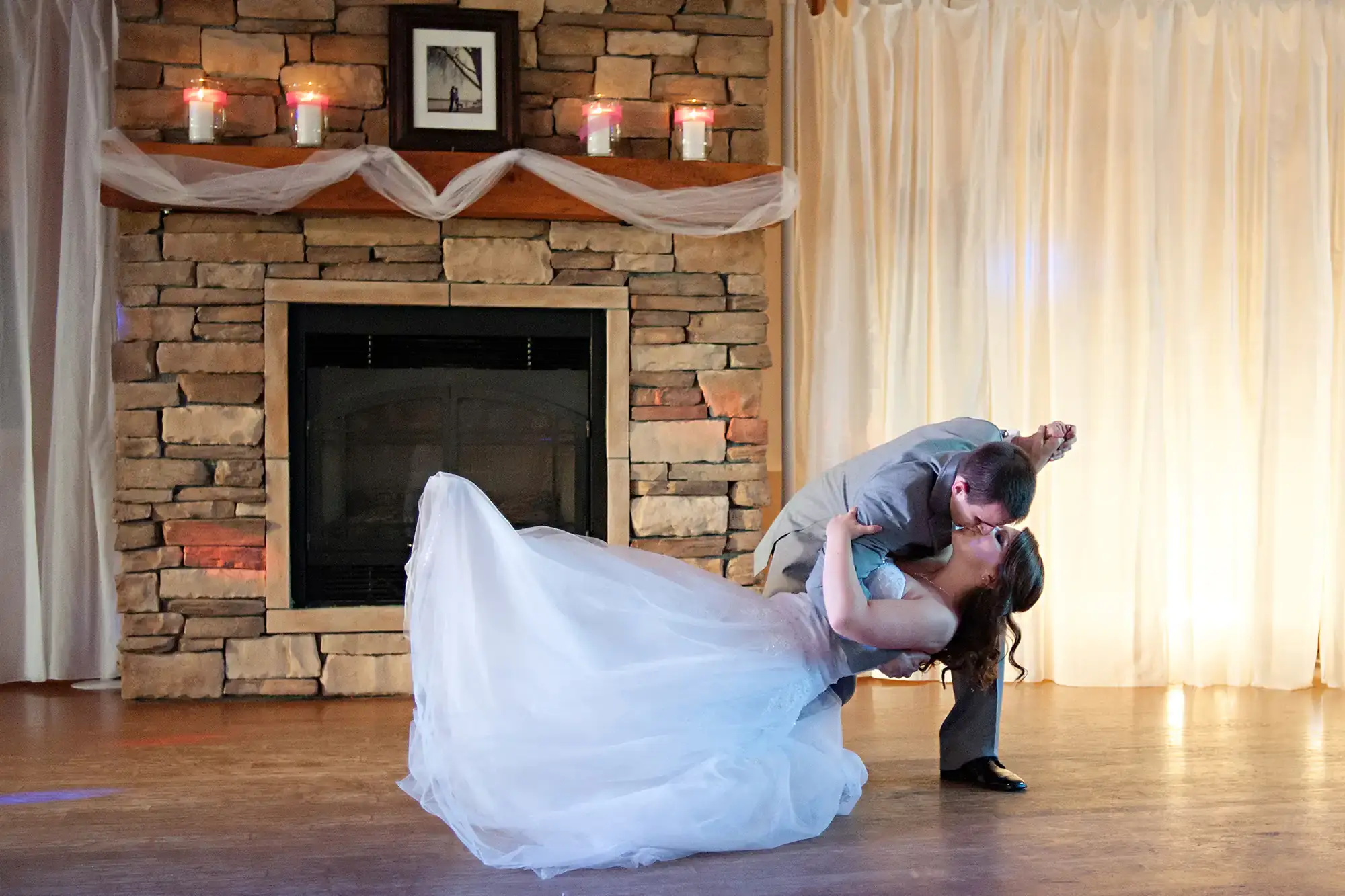 Couple sharing a romantic dip kiss during their first dance at Valiant Vineyards